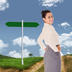 Worried businesswoman against road leading out to the horizon