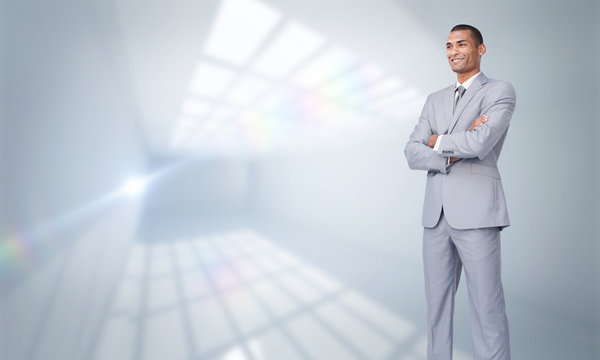 Charismatic Attractive businessman with folded arms against room with windows at ceiling