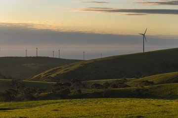 Fototapeta na wymiar Wind farm on rolling green hills