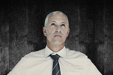 Businessman thinking against black background