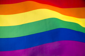 Gay pride rainbow flag fills the frame for a colorful background