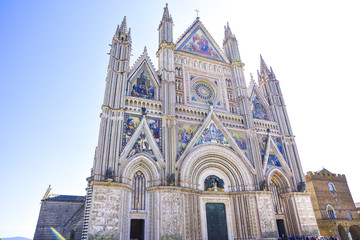 Fototapeta na wymiar Facade of the Cathedral of Orvieto (Duomo di Orvieto) Italy. Construction in Gothic style dedicated to the Virgin Mary