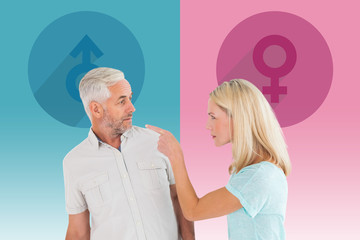 Unhappy couple having an argument  against pink and blue