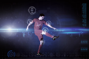 Football player in yellow kicking against blue dots on black background