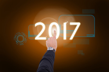 Businessman hand with watch pointing something  against orange background with vignette