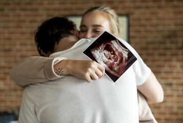 White couple with baby ultrasound photo - obrazy, fototapety, plakaty
