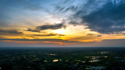 Panorama Top view Aerial photo from flying drone over village in Thailand.Top view beautiful Sunset.Sunrise with cloud over rice field.