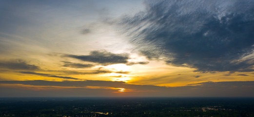 Panorama Top view Aerial photo from flying drone over village in Thailand.Top view beautiful Sunset.Sunrise with cloud over rice field.