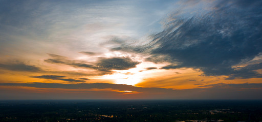 Panorama Top view Aerial photo from flying drone over village in Thailand.Top view beautiful Sunset.Sunrise with cloud over rice field.
