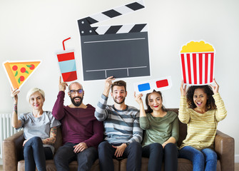 Group of diverse friends watchin movie together