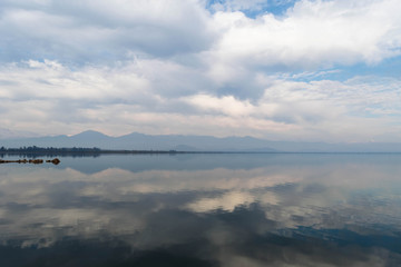 Symmetrical cloudy sky reflection in the water surface of Convento Viejo Dam in Chile, VI region near Chimbarongo and San Fernando
