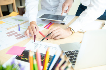 business group working check chart and paper data with laptop on desk in office, taplet in hands for present and checking big project