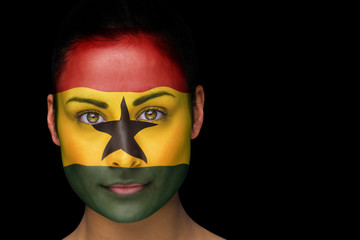 Composite image of ghana football fan in face paint against black
