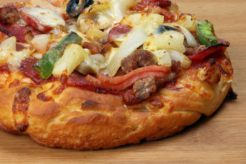 Pizza beef chicken peperoni cheese chilli capsicum onion olive on wooden board