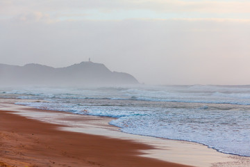 Byron Bay Lighthouse on a cliff disappearing in the morning mist. Byron Bay, New South Wales, Australia - 203166935