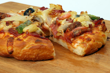 Pizza beef chicken peperoni cheese chilli capsicum onion olive on wooden board