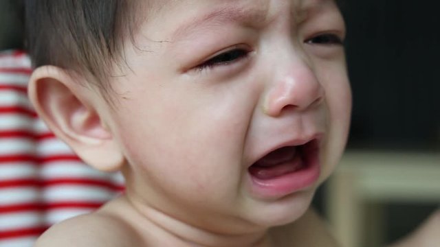 baby cry with tears falling, unhappy feeling