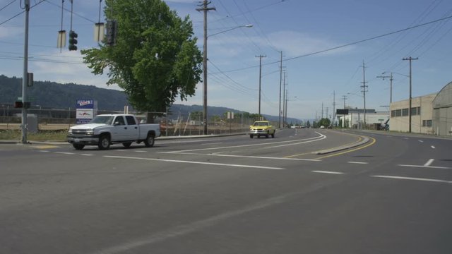 Right Front Three Quarter view of a Driving Plate: Car travels on NW Nicolai Street in Portland, Oregon, turns left onto NW 24th Avenue, left onto NW York Street, and continues for several blocks though an industrial warehouse area before turning left onto NW 21st Avenue. It continues on NW 21st to the intersection at NW Front Avenue.