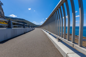 Walking path along the Sea Cliff Bridge on Grand Pacific Drive in Sydney, Australia