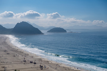 view of Copacabana and Leme beach during early morning, taken from the rooftop of a hotel, some slight fog can be seen on the blue sky. Rio de Janeiro, Brazil
