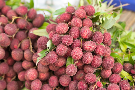 Ripe lychee fruits on table in local market