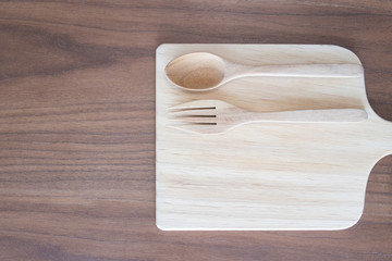 kitchen were, wood dish , spoon and fork on wooden table, top view