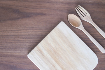 kitchen were, wood dish , spoon and fork on wooden table, top view