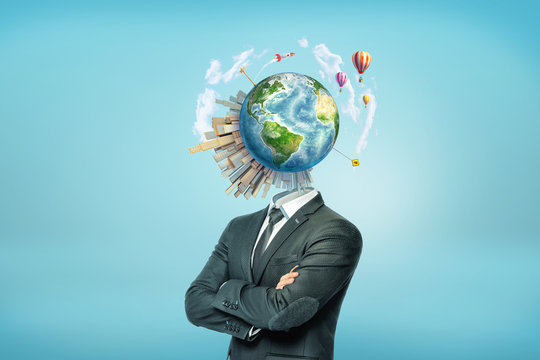 A businessman's torso with an Earth globe surrounded by buildings, rockets and hot air balloons instead of his head.