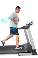 Full length of a young man running on a treadmill against fitness interface