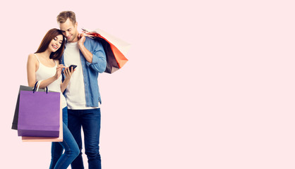 Couple with shopping bags and cellphone