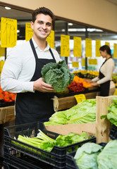 Fototapeta premium shop people standing near cabbage in grocery