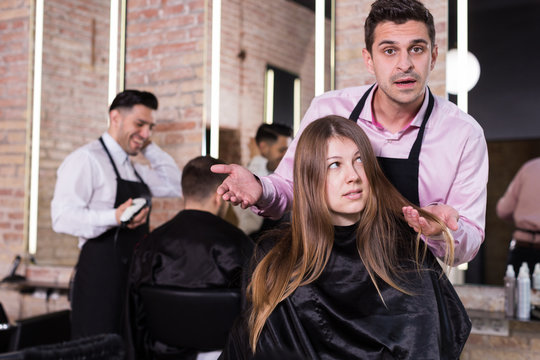 Female discussing haircut with hairdresser