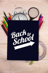 Back to school message with arrow against students desk with black page
