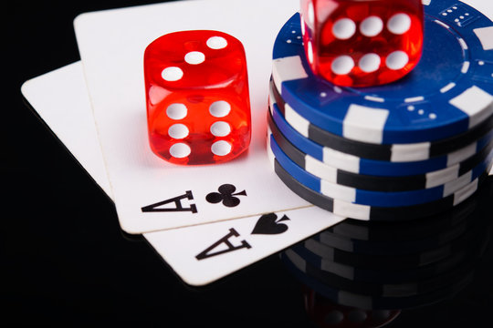 two aces, poker chips and red cubes, on a black background with mappings