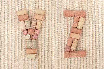 Alphabet letter Y and Z made of wine corks on jute rope background