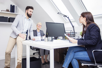Group of young people working on curent project in office