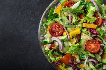 tomatoes, bell pepper, cucumber, lettuce and red onion salad