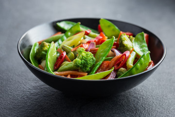 stir fry vegetables in black bowl