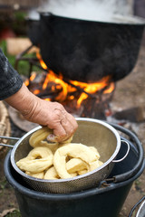 Old woman boiling homemade bagels