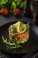 delicious avocado and salted salmon tartar, served with arugula