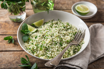 couscous with lemon and herbs in white bowl
