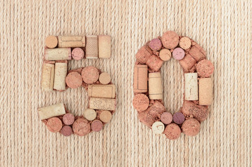 Number fifty 50  made of wine corks on jute rope background