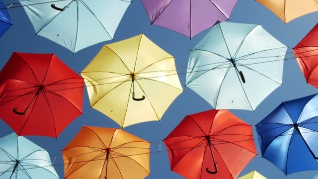 flying colored umbrellas. soft pastel colors