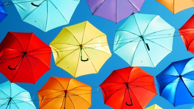 flying colored umbrellas. vivid colors