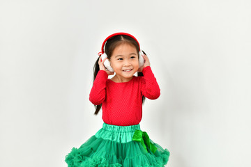 Little girl celebrates Christmas with red Santa dress.