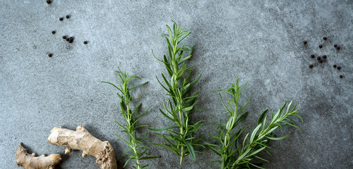 Various herbs and spices on gray stone