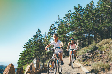 Child and girl riding bikes