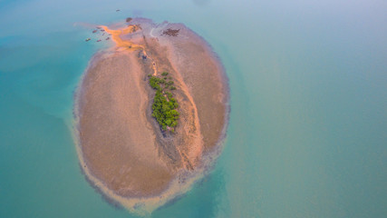Coral emerges from the water at a reduced water level.