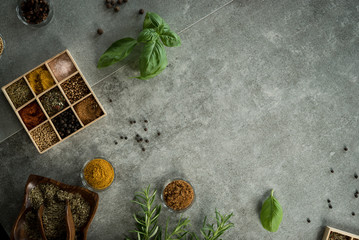 A collection of fresh spices on a gray stone table