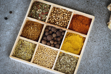 A collection of fresh spices on a gray stone table